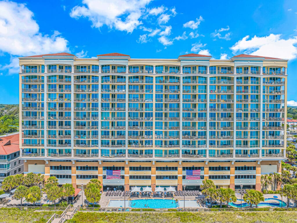 Oceanfront face of Mar Vista Grande with balconies above the outdoor pool deck