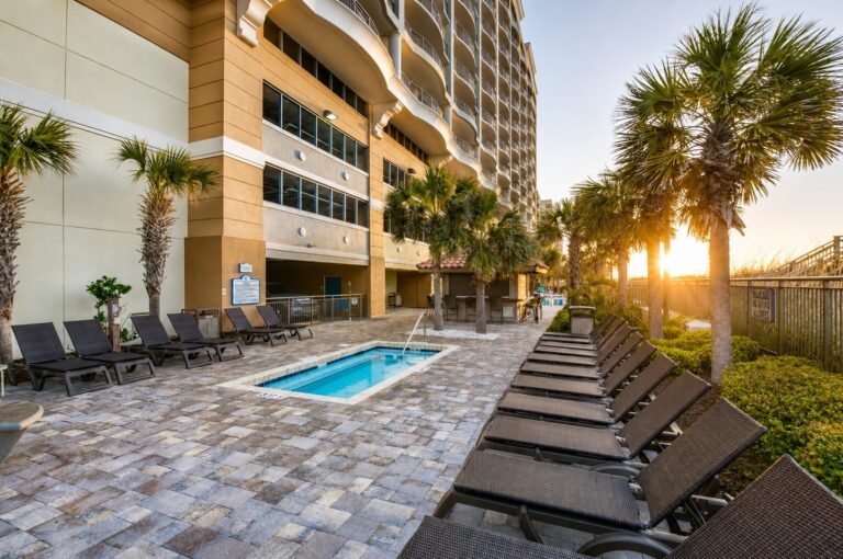 Outdoor hot tub and lounge chairs at sunrise at Mar Vista Grande